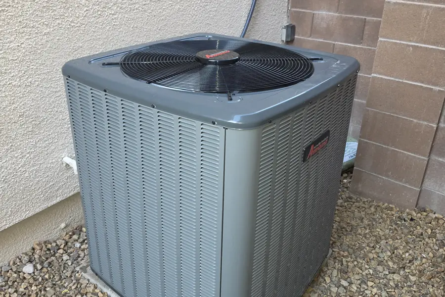 Air conditioner condenser on a gravel pad beside a Las Vegas home