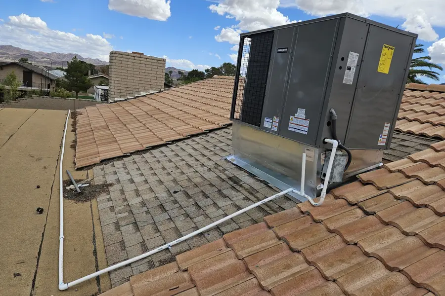 Rooftop package heating and cooling unit on a tile roof